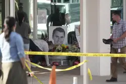 The Latest: FBI releases photos of a person of interest in Kirk assassination